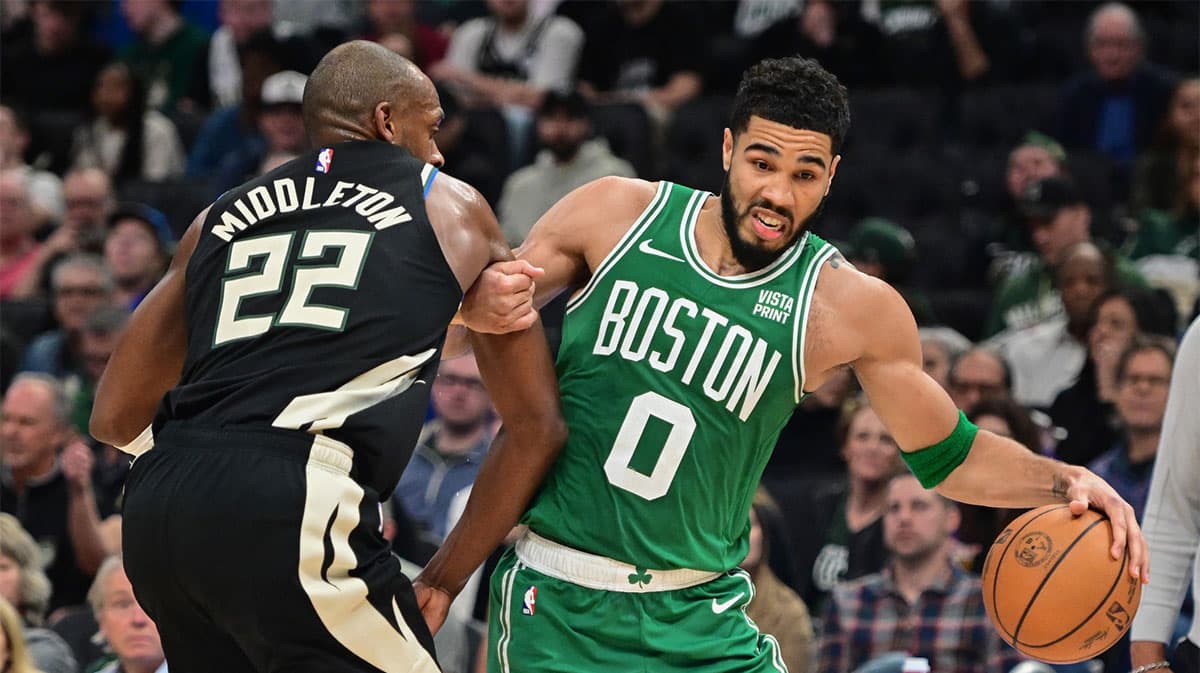 Boston Celtics forward Jayson Tatum (0) drives past Milwaukee Bucks forward Khris Middleton (22) in the third quarter at Fiserv Forum.