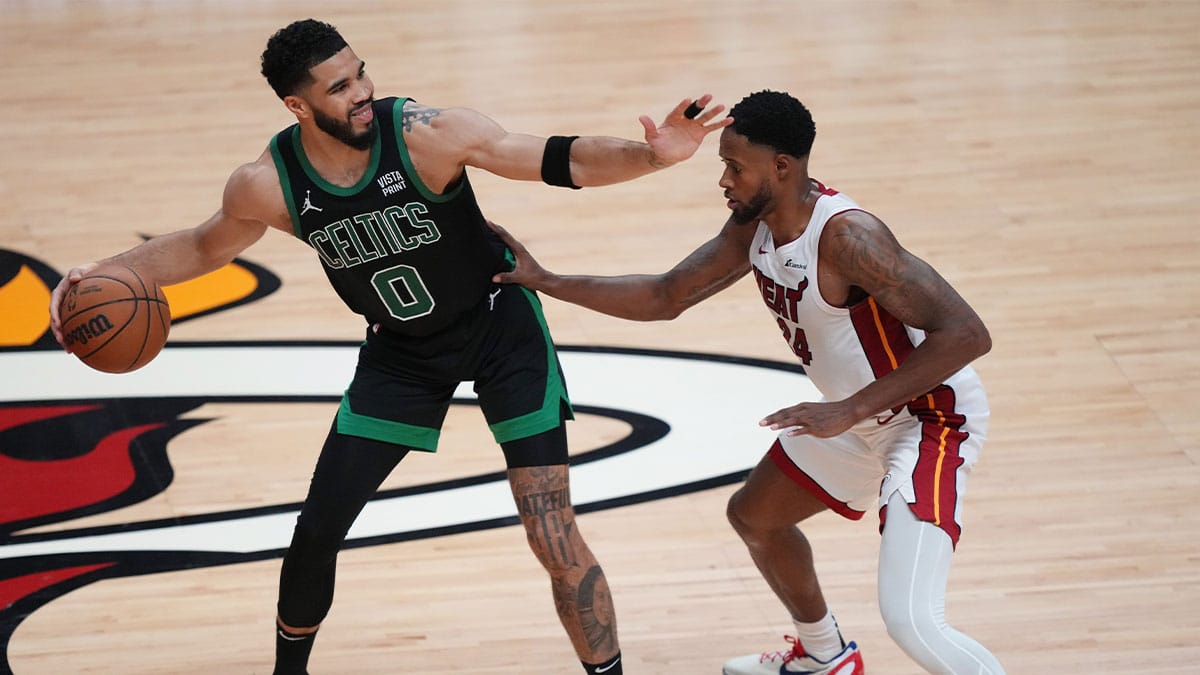 Boston Celtics forward Jayson Tatum (0) directs the offense as Miami Heat forward Haywood Highsmith (24) defends in the second half during game three of the first round for the 2024 NBA playoffs at Kaseya Center.