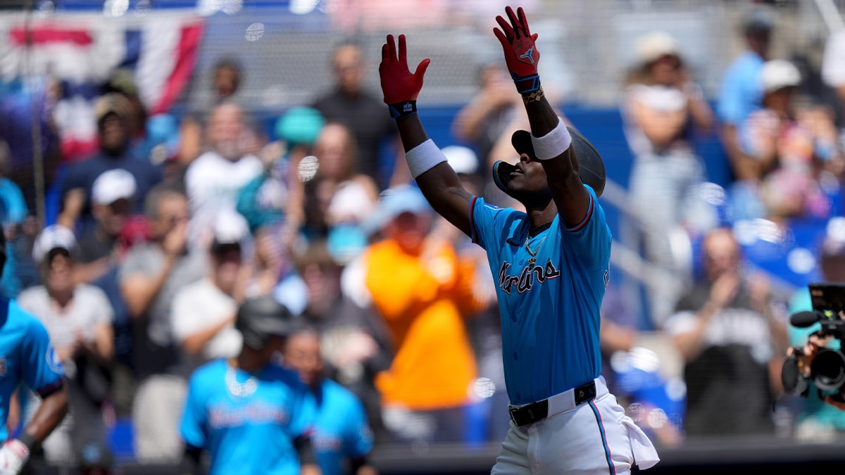 Miami Marlins center fielder Jazz Chisholm Jr. (2) celebrates his grand slam as he crosses home plate against the Pittsburgh Pirates in the first inning at loanDepot Park