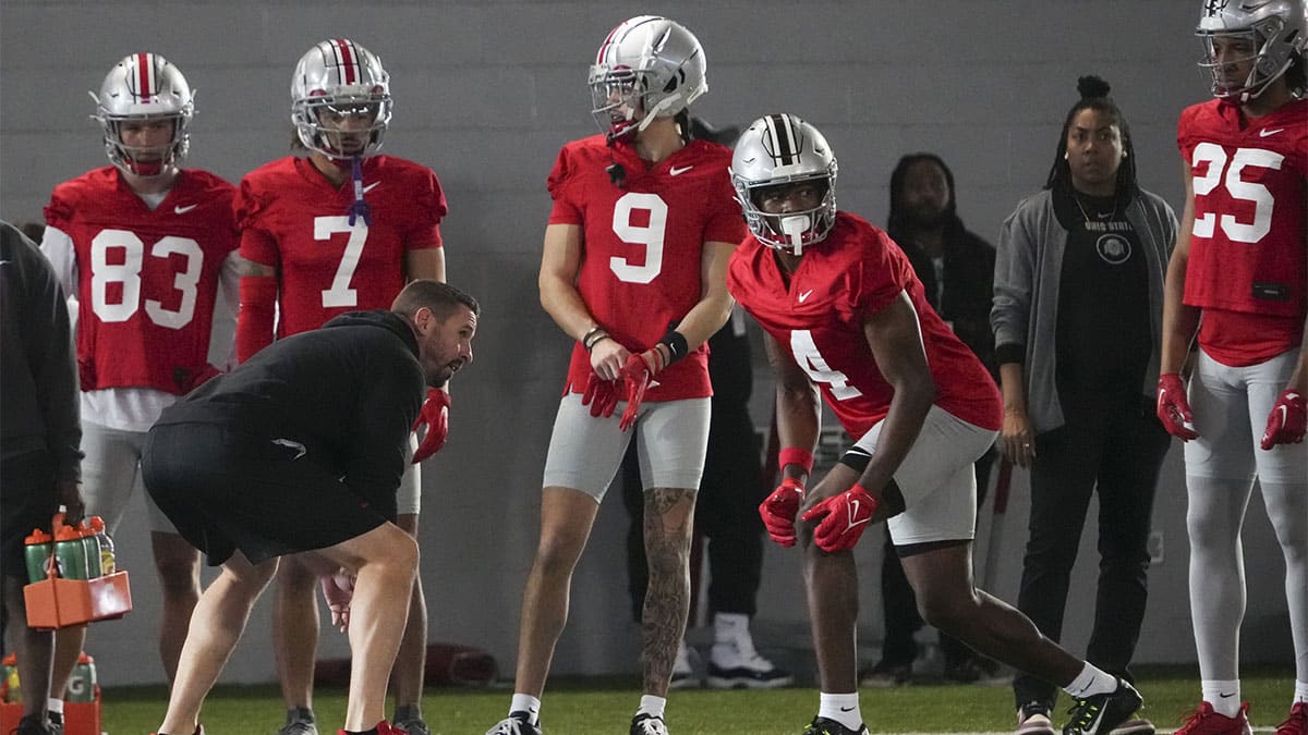 Ohio State Buckeyes offensive coordinator Brian Hartline lines up beside wide receiver Jeremiah Smith (4) during the first spring practice at the Woody Hayes Athletic Center.