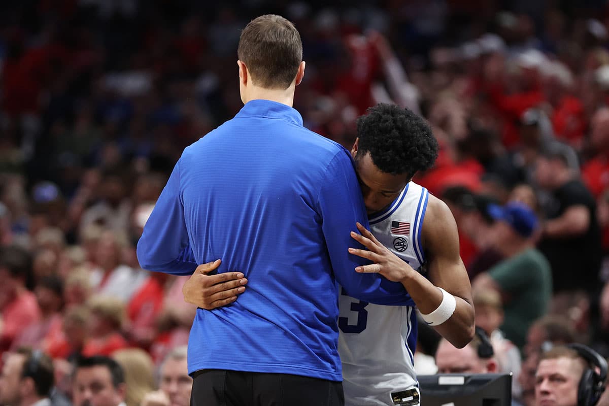 Duke Blue Devils guard Jeremy Roach (3) and head coach Jon Scheyer embrace in the second half against the North Carolina State Wolfpack in the finals of the South Regional of the 2024 NCAA Tournament at American Airline Center.