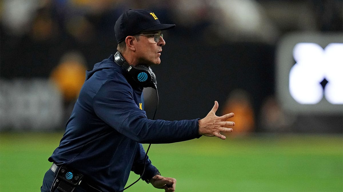 Michigan Wolverines head coach Jim Harbaugh celebrates after his team scored a touchdown during the fourth quarter against the Washington Huskies in the 2024 College Football Playoff national championship game at NRG Stadium. 
