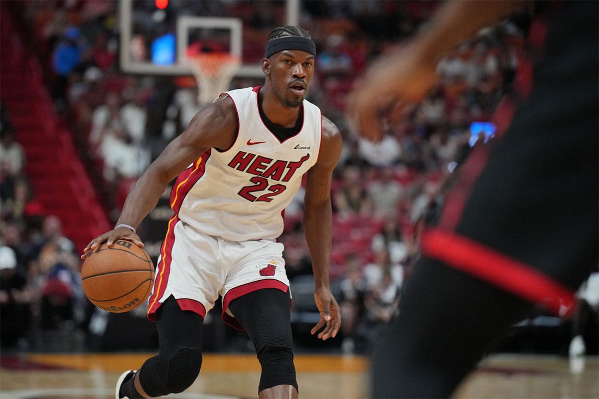  Miami Heat forward Jimmy Butler (22) brings the ball up the court against the Toronto Raptors during the first half at Kaseya Center. 