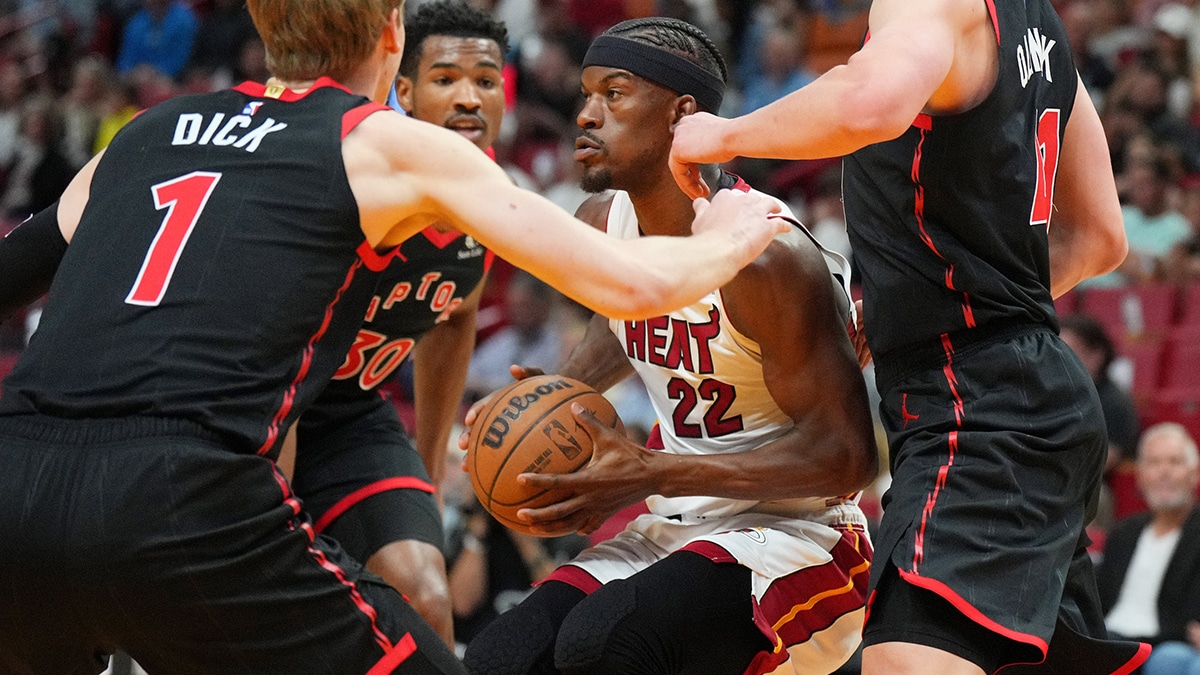 Miami Heat forward Jimmy Butler (22) gets surrounded by the Toronto Raptors defense during the first half at Kaseya Center.