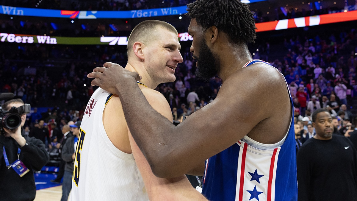 Philadelphia 76ers center Joel Embiid (21) hugs and talks with Denver Nuggets center Nikola Jokic (15) after the game at Wells Fargo Center.