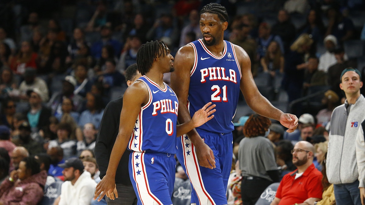 Philadelphia 76ers guard Tyrese Maxey (0) and center Joel Embiid (21) talk as they walk off the court at half time against the Memphis Grizzlies at FedExForum. 