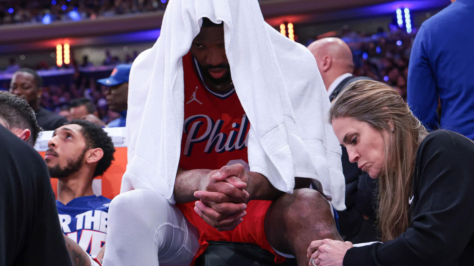 Philadelphia 76ers center Joel Embiid (21) is looked at by medical staff during the second half during game two of the first round for the 2024 NBA playoffs against the New York Knicks at Madison Square Garden