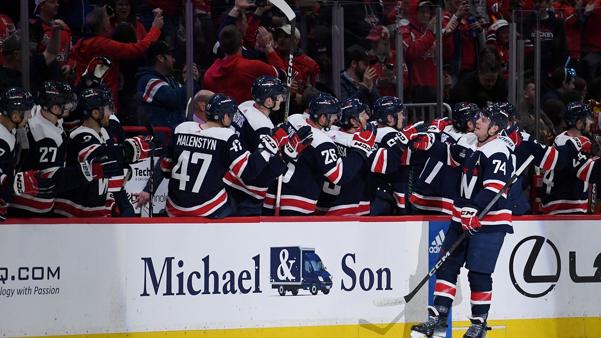 Washington Capitals defenseman John Carlson (74) celebrates with teammates after scoring a goal against the Boston Bruins during the second period at Capital One Arena.
