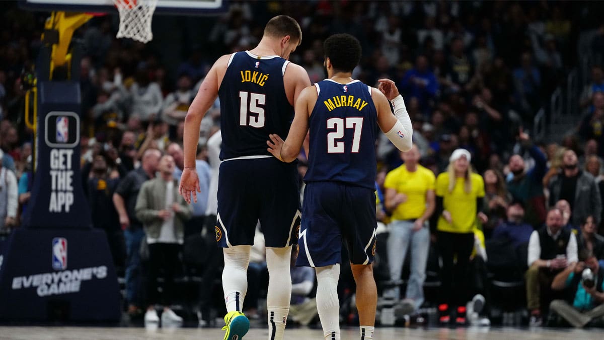 Denver Nuggets center Nikola Jokic (15) and guard Jamal Murray (27) talk in the fourth quarter against the Minnesota Timberwolves at Ball Arena.