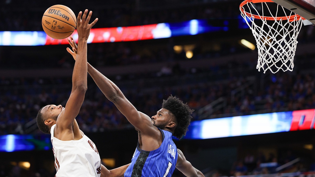 Orlando Magic forward Jonathan Isaac (1) blocks the shot of Cleveland Cavaliers forward Evan Mobley (4) in the fourth quarter during game four of the first round for the 2024 NBA playoffs at Kia Center.