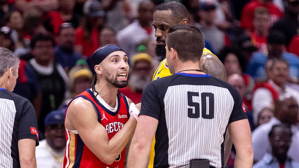 New Orleans Pelicans guard Jose Alvarado (15) discusses a play with referee Gediminas Petraitis (50) against Los Angeles Lakers forward LeBron James (23) during the second half of a play-in game of the 2024 NBA playoffs at Smoothie King Center. 