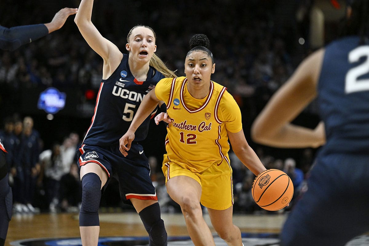 USC Trojans guard JuJu Watkins (12) drives to the basket during the second half against UConn Huskies guard Paige Bueckers (5) in the finals of the Portland Regional of the NCAA Tournament at the Moda Center.