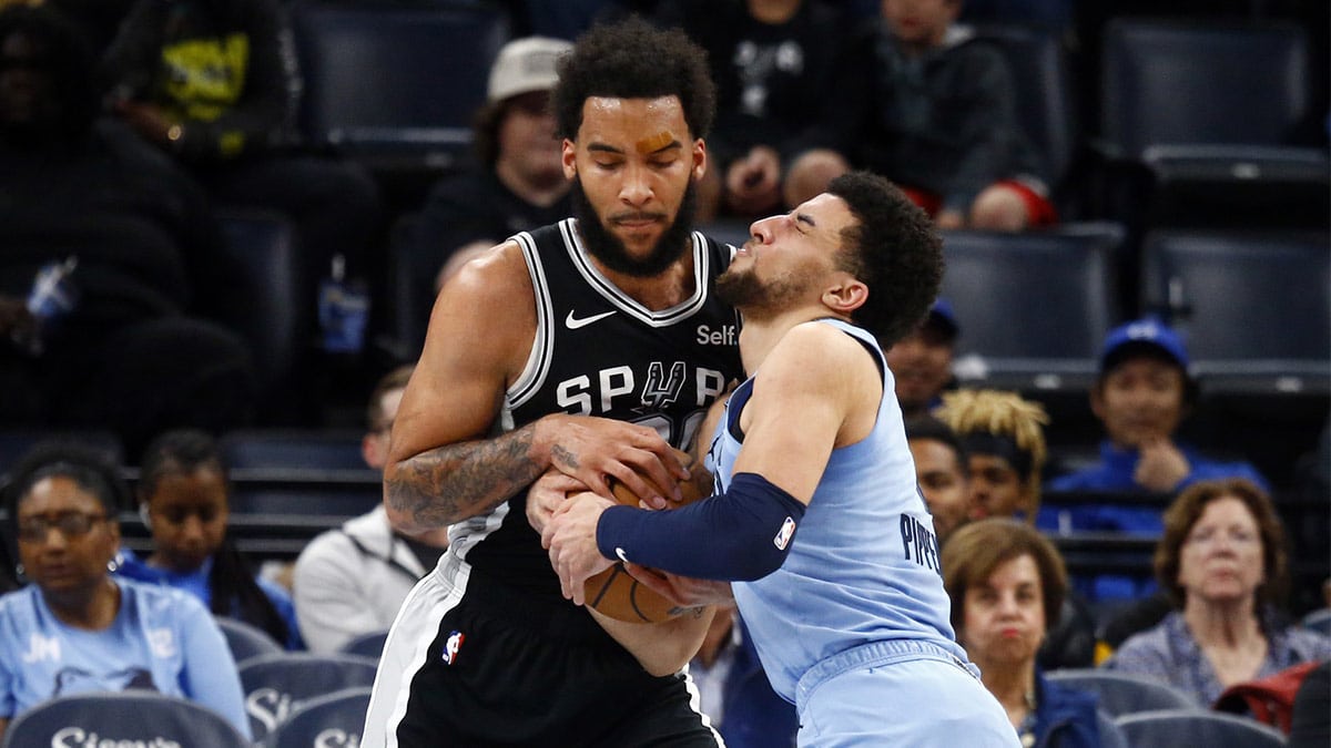 San Antonio Spurs forward Julian Champagnie (30) and Memphis Grizzlies guard Scotty Pippen Jr. (1) battle for the ball during the second half at FedExForum.