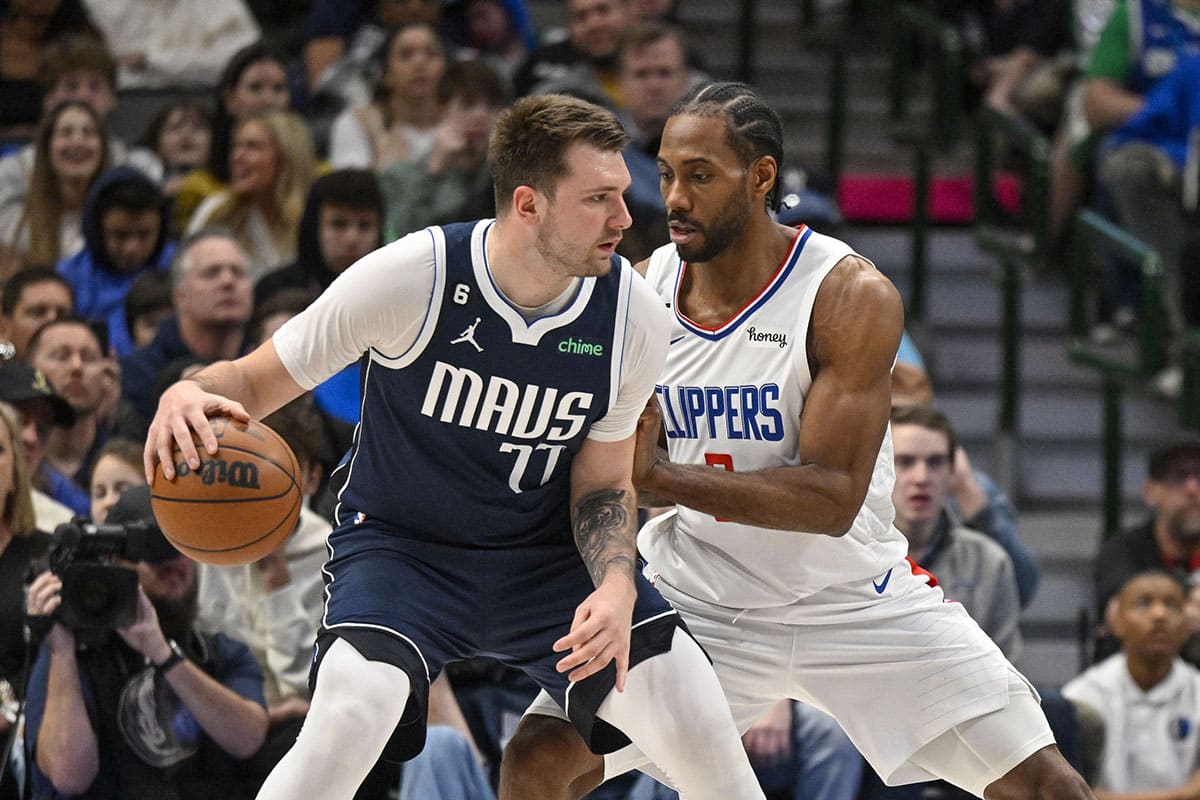 Dallas Mavericks guard Luka Doncic (77) looks to move the ball past LA Clippers forward Kawhi Leonard (2) during the second half at the American Airlines Center. 