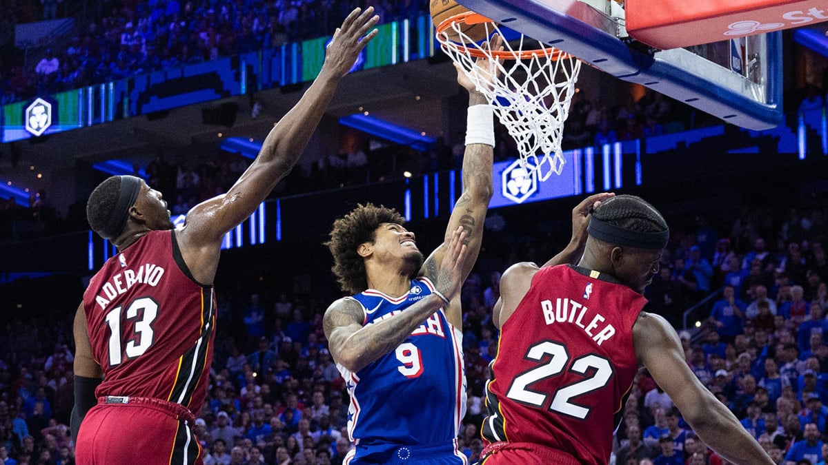 Philadelphia 76ers guard Kelly Oubre Jr. (9) drives for a score past Miami Heat center Bam Adebayo (13) and forward Jimmy Butler (22) during the fourth quarter of a play-in game of the 2024 NBA playoffs at Wells Fargo Center.