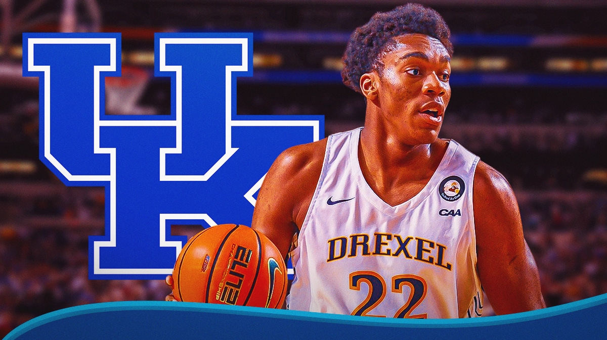 Transfer portal center Amari Williams stands next to Kentucky basketball logo, Mark Pope sits on sidelines