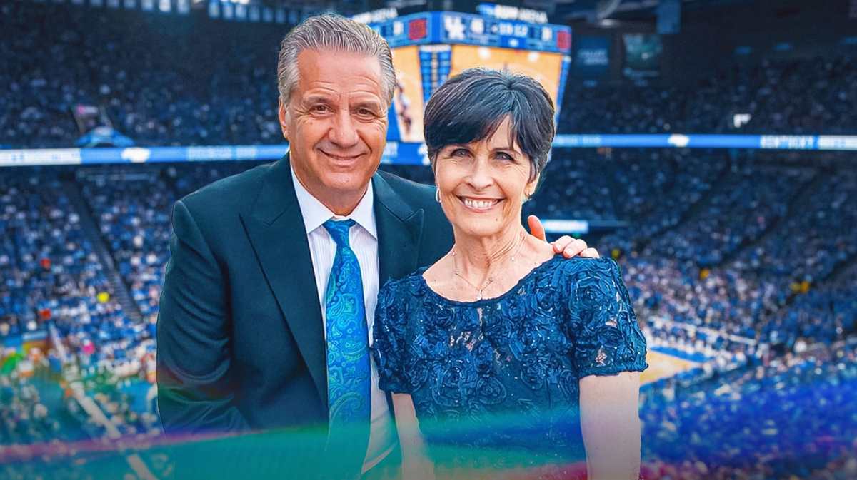 Kentucky basketball's John Calipari stands next to wife Ellen, Arkansas basketball fans in stands