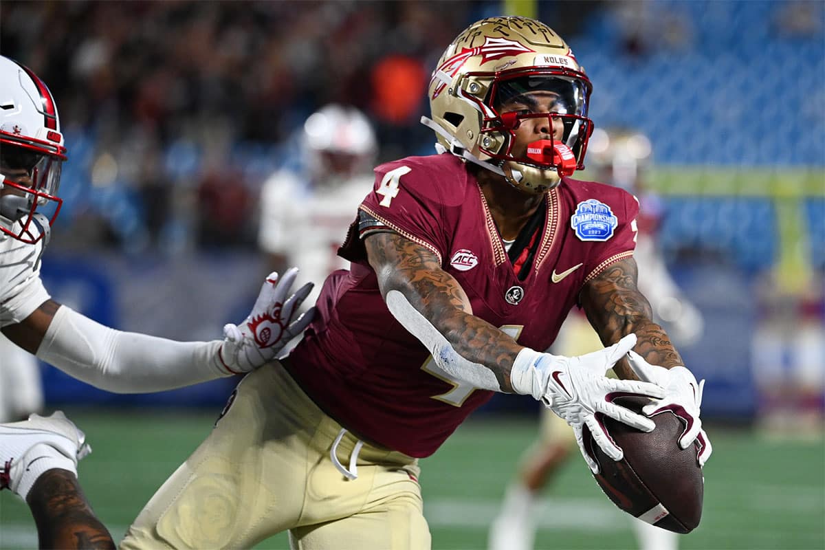 Florida State Seminoles wide receiver Keon Coleman (4) makes a catch against the Louisville Cardinals in the second quarter at Bank of America Stadium