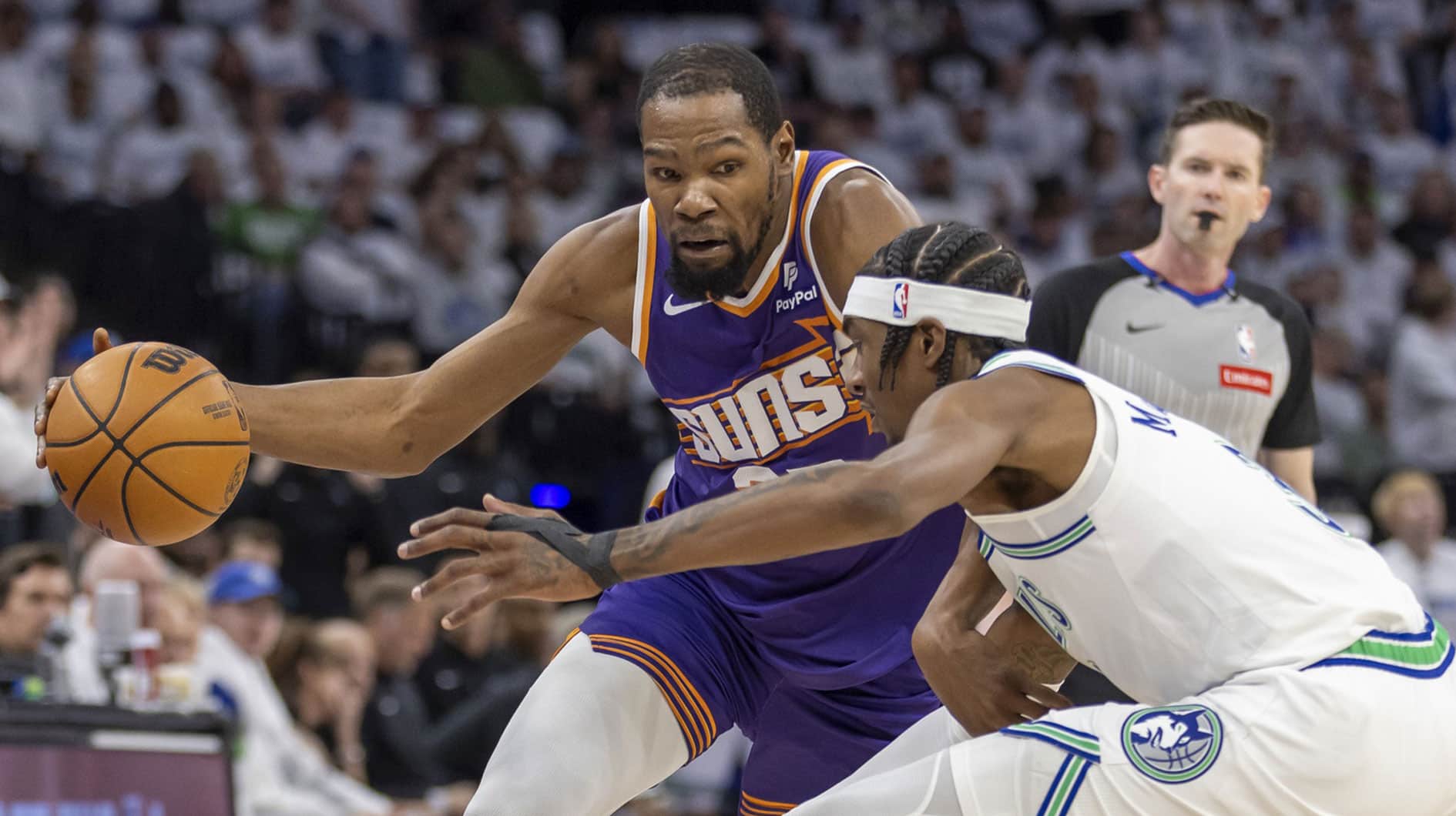 Apr 20, 2024; Minneapolis, Minnesota, USA; Phoenix Suns forward Kevin Durant (35) dribbles the ball around Minnesota Timberwolves forward Jaden McDaniels (3)] in the first half during game one of the first round for the 2024 NBA playoffs at Target Center. 