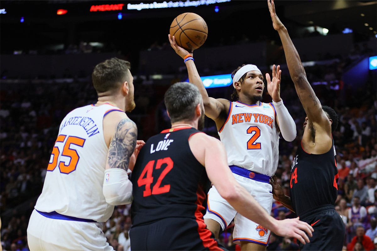 New York Knicks guard Miles McBride (2) drives to the basket against Miami Heat forward Haywood Highsmith (24) during the second quarter at Kaseya Center.