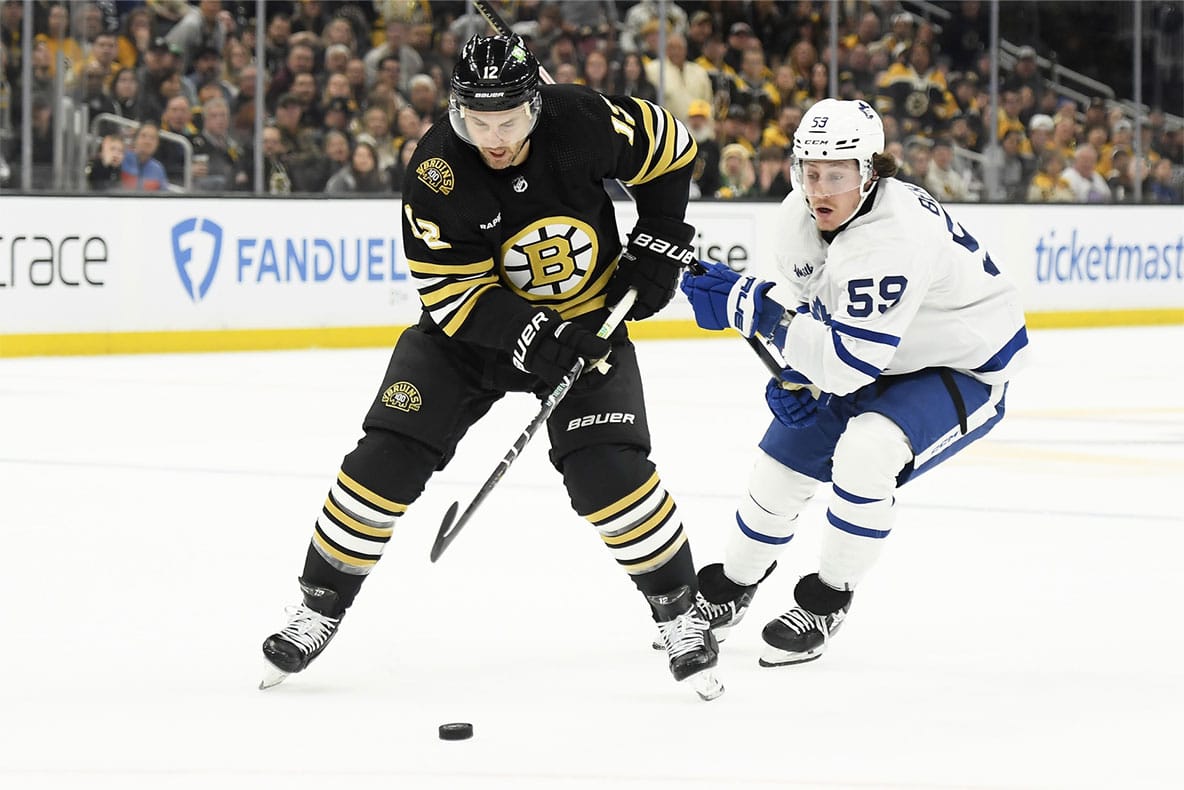Boston Bruins defenseman Kevin Shattenkirk (12) controls the puck while Toronto Maple Leafs left wing Tyler Bertuzzi (59) defends during the first period in game one of the first round of the 2024 Stanley Cup Playoffs at TD Garden.