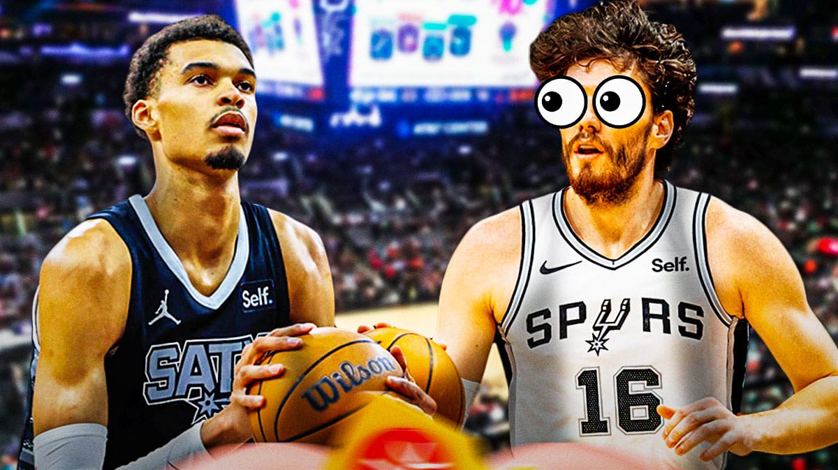 Spurs' Cedi Osman with heart emoji eyes looking at Victor Wembanyama