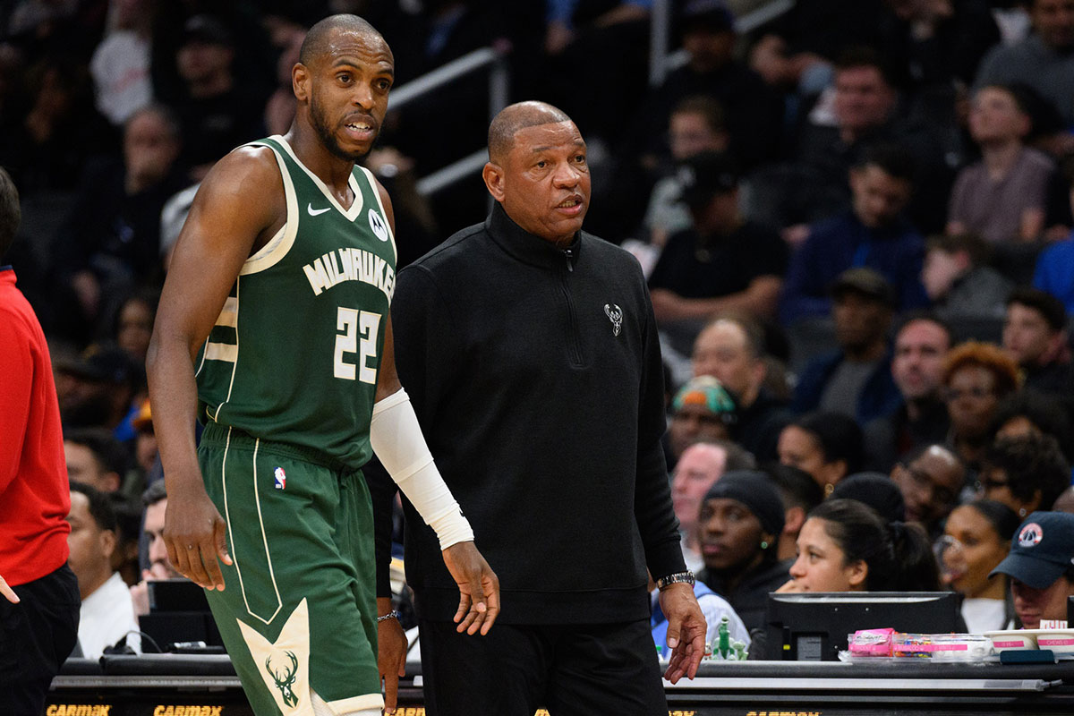 Milwaukee Bucks forward Khris Middleton (22) and head coach Doc Rivers look on during the second quarter against the Washington Wizards at Capital One Arena. 