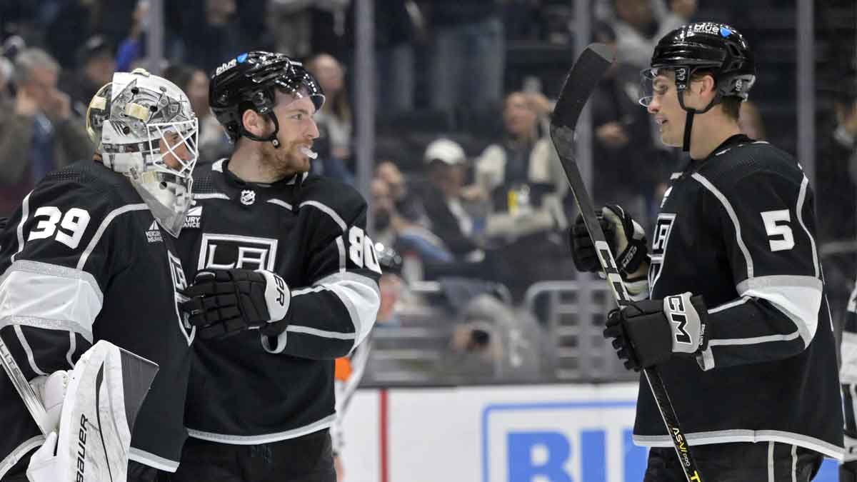 Los Angeles Kings center Pierre-Luc Dubois (80) and defenseman Andreas Englund (5) congratulate goaltender Cam Talbot (39) after defeating the Calgary Flames at Crypto.com Arena.
