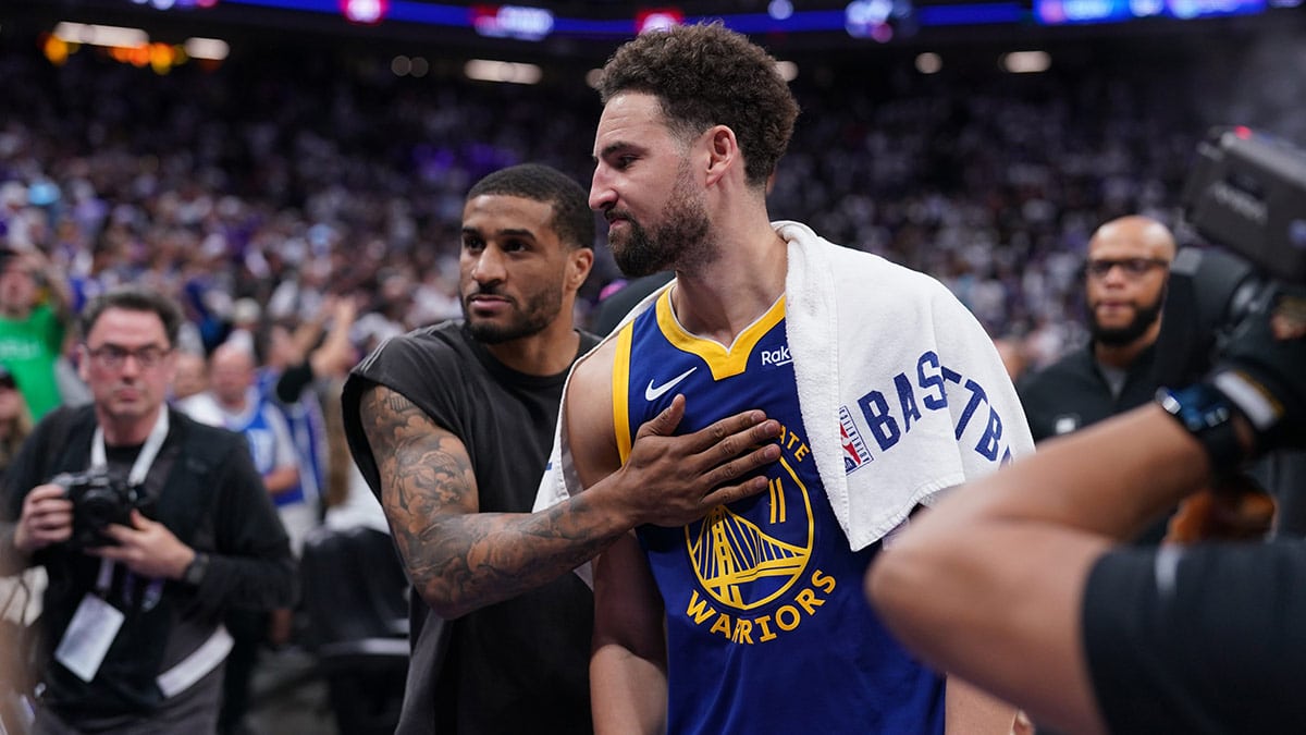 Golden State Warriors guard Klay Thompson (11) and guard Gary Payton II (0) walk towards the locker room after the Warriors lost to the Sacramento Kings during a play-in game of the 2024 NBA playoffs at the Golden 1 Center.