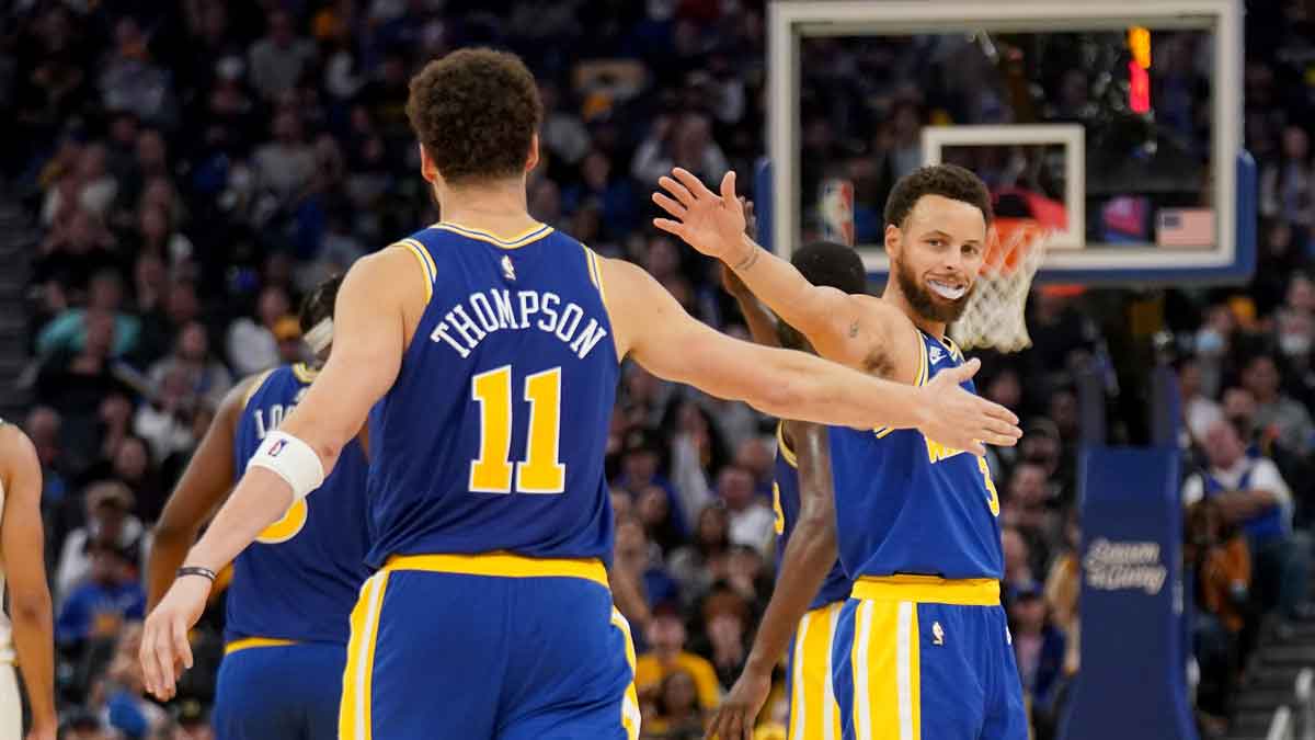 Golden State Warriors guard Stephen Curry (30) meets with guard Klay Thompson (11) after a play against the Boston Celtics in the fourth quarter at the Chase Center. 