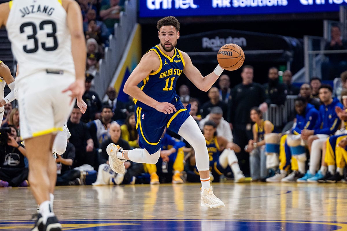 Golden State Warriors guard Klay Thompson (11) dribbles the ball during the first quarter against the Utah Jazz at Chase Center