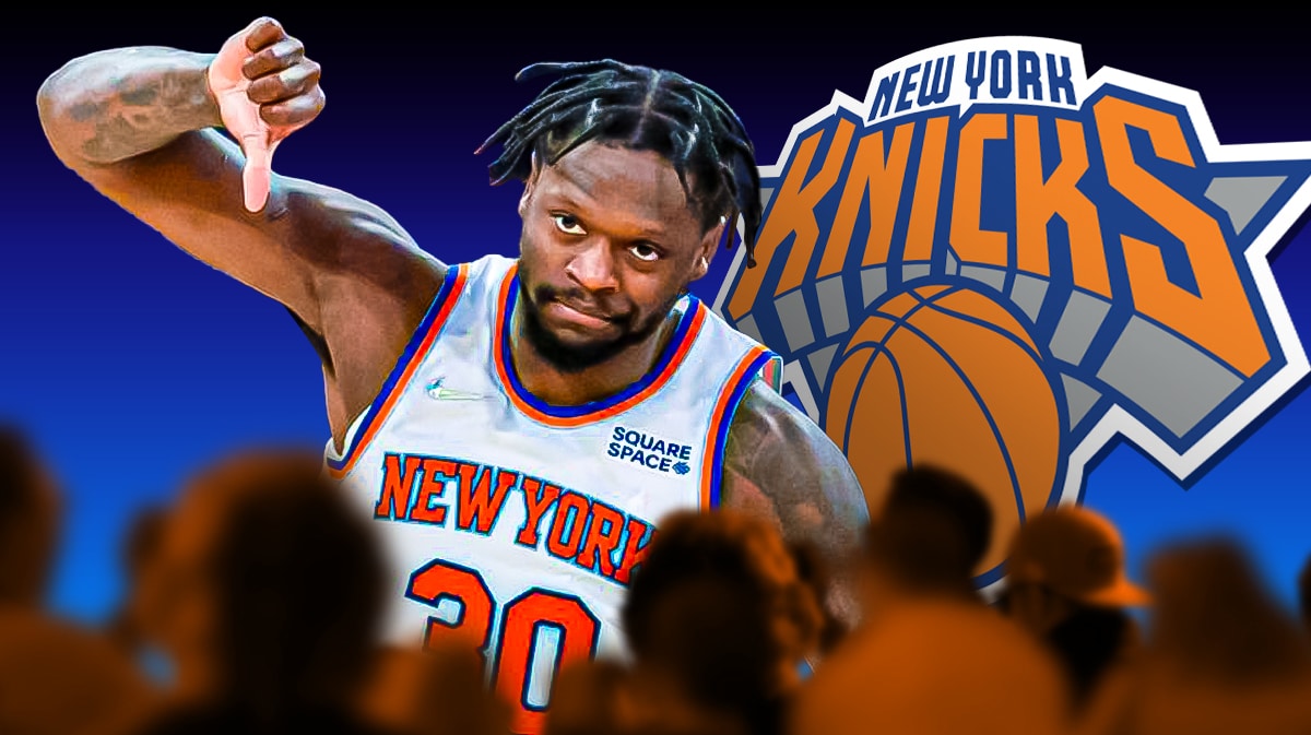 Julius Randle giving the thumbs down with the Knicks logo behind him.