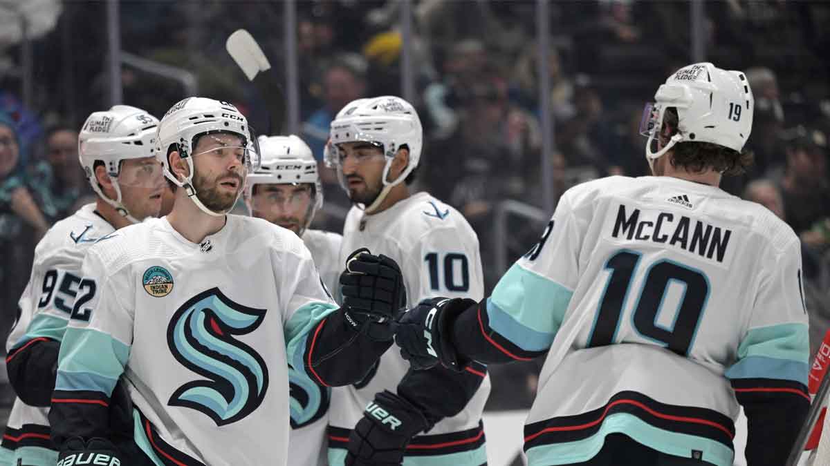 Seattle Kraken right wing Oliver Bjorkstrand (22), left, is congratulated by center Matty Beniers (10) after scoring a goal in the third period against the Los Angeles Kings at Crypto.com Arena.