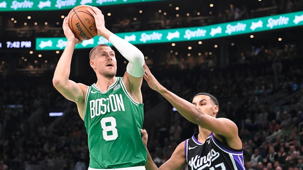 Boston Celtics center Kristaps Porzingis (8) shoots the ball against Sacramento Kings forward Keegan Murray (13) during the first half at TD Garden.