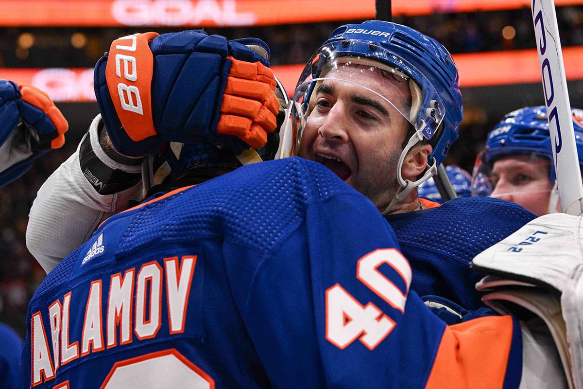 New York Islanders center Kyle Palmieri (21) celebrates the 3-2 victory against the Montreal Canadiens after the game with New York Islanders goaltender Semyon Varlamov (40) period at UBS Arena.