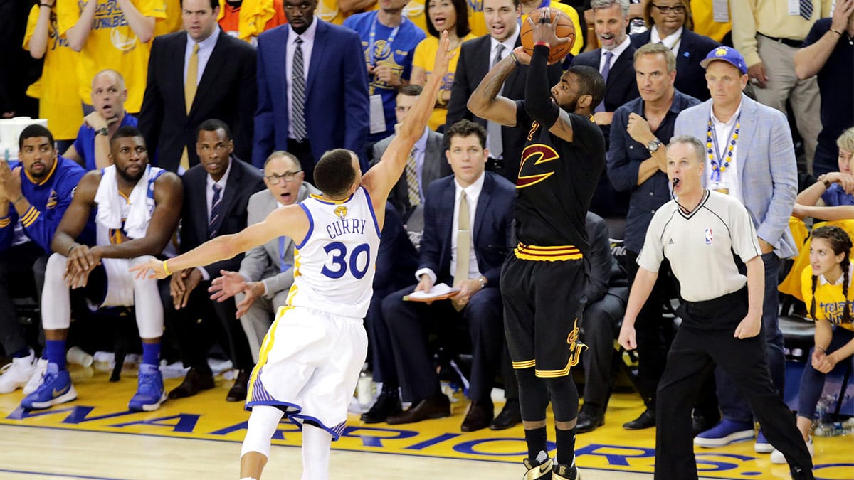 Cleveland Cavaliers guard Kyrie Irving (2) shoots the the game winning shot during the fourth quarter against Golden State Warriors guard Stephen Curry (30) in game seven of the NBA Finals at Oracle Arena. 