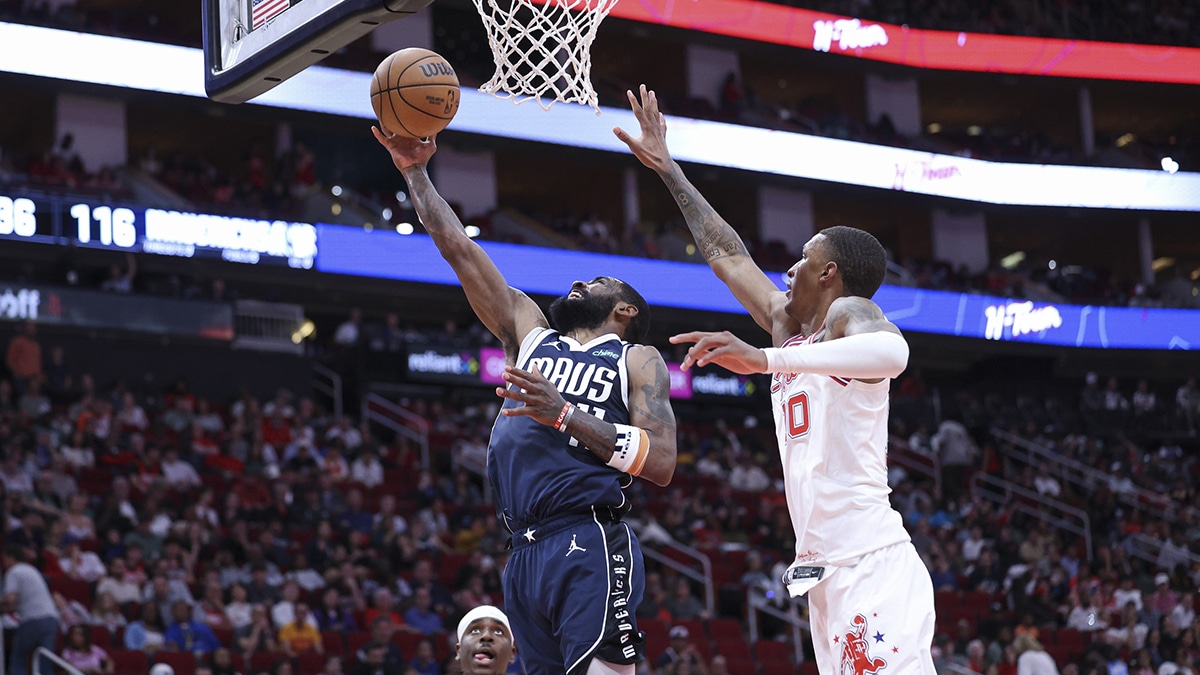 Dallas Mavericks guard Kyrie Irving (11) shoots the ball as Houston Rockets forward Jabari Smith Jr. (10) defends during the fourth quarter at Toyota Center.