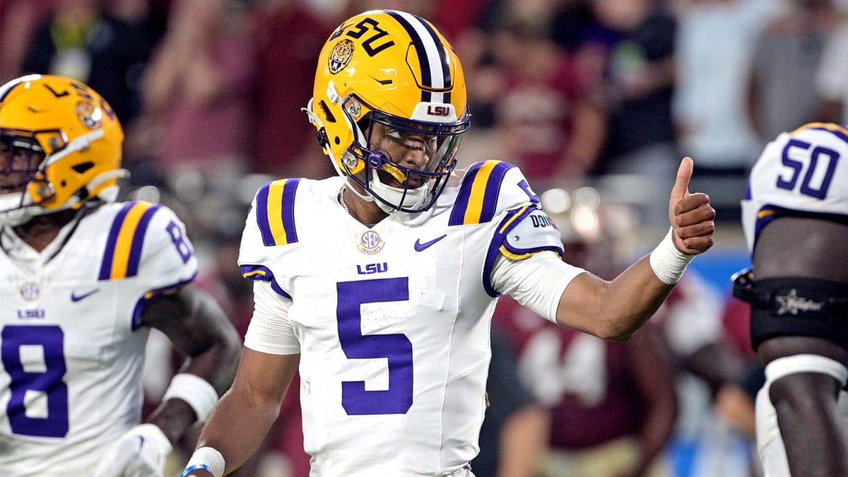 LSU Tigers quarterback Jayden Daniels (5) gives a thumbs up during the first half against the Florida State Seminoles at Camping World Stadium.