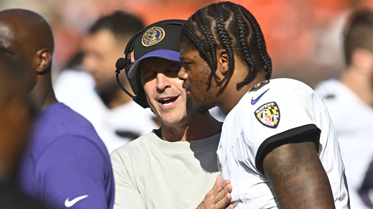 Baltimore Ravens head coach John Harbaugh talks with quarterback Lamar Jackson (8) in the fourth quarter against the Cleveland Browns at Cleveland Browns Stadium