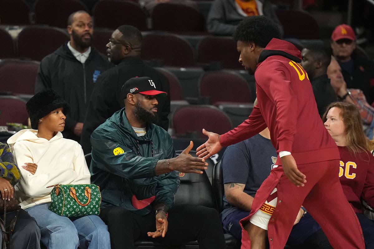 Southern California Trojans guard Bronny James (6) is greeted by father LeBron James during the game against the Washington State Cougars at Galen Center.