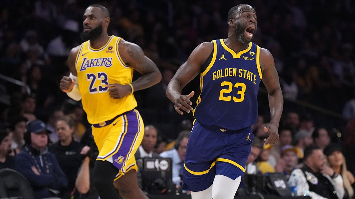  Golden State Warriors forward Draymond Green (right) and Los Angeles Lakers forward LeBron James react in the first half at Crypto.com Arena.