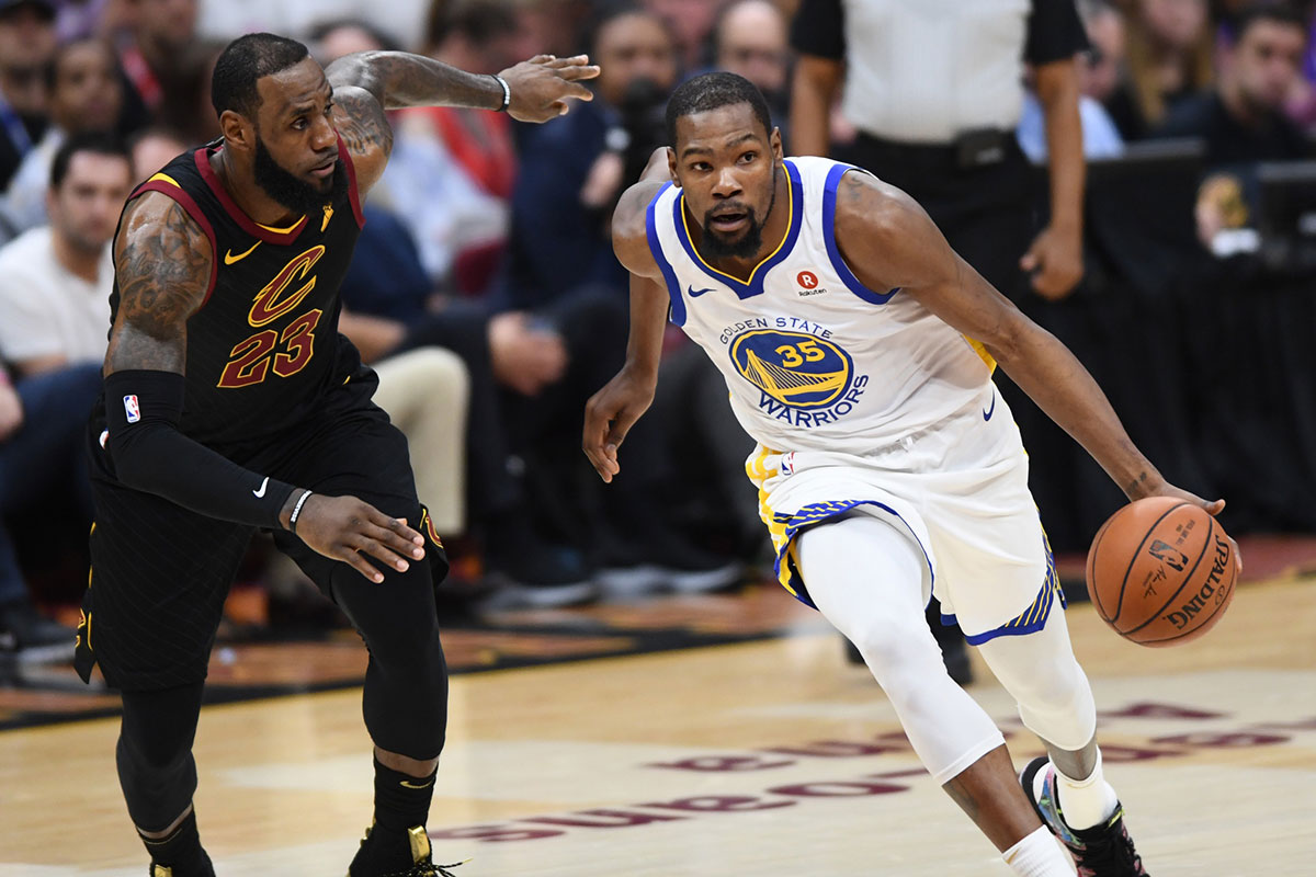 Golden State Warriors forward Kevin Durant (35) dribbles against Cleveland Cavaliers forward LeBron James (23) during the first quarter in game four of the 2018 NBA Finals at Quicken Loans Arena.