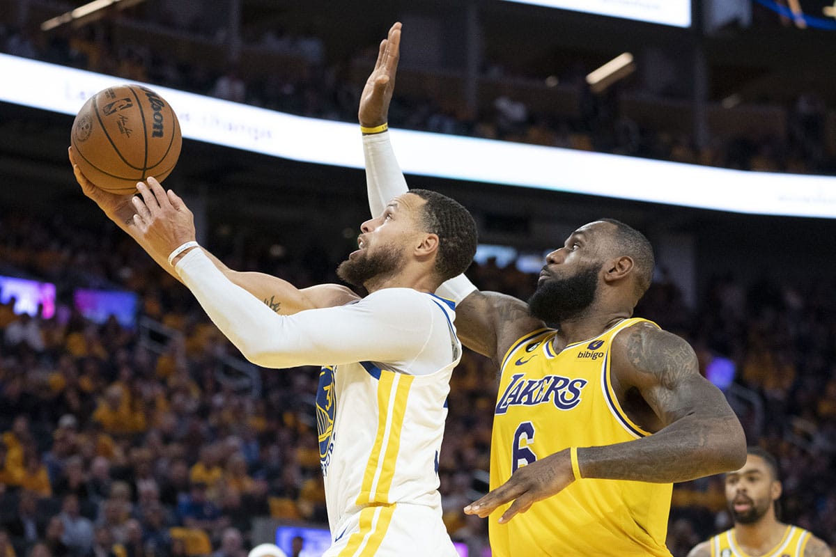 Golden State Warriors guard Stephen Curry (30) shoots the basketball against Los Angeles Lakers forward LeBron James (6) during the third quarter in game five of the 2023 NBA playoffs conference semifinals round at Chase Center.
