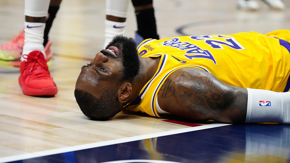 Los Angeles Lakers forward LeBron James (23) lays on the court in the second quarter against the Denver Nuggets during game two of the first half during the 2024 NBA playoffs at Ball Arena. 