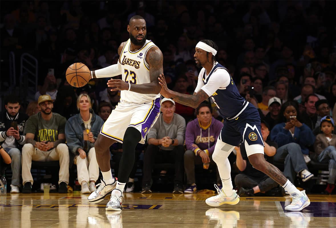 Los Angeles Lakers player LeBron James guarded by Denver Nuggets player Kentavious Caldwell-Pope