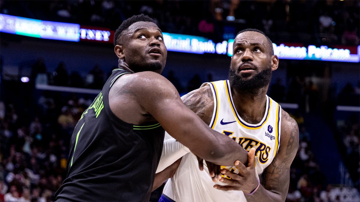 Los Angeles Lakers forward LeBron James (23) and New Orleans Pelicans forward Zion Williamson (1) fight for position during the second half at Smoothie King Center.