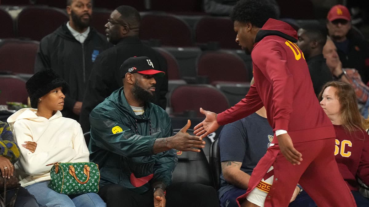 Southern California Trojans guard Bronny James (6) is greeted by father LeBron James during the game against the Washington State Cougars at Galen Center.