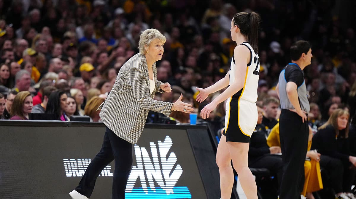 Iowa Hawkeyes head coach Lisa Bluder and guard Caitlin Clark (22) react in the third quarter against the Connecticut Huskies in the semifinals of the Final Four of the womens 2024 NCAA Tournament.