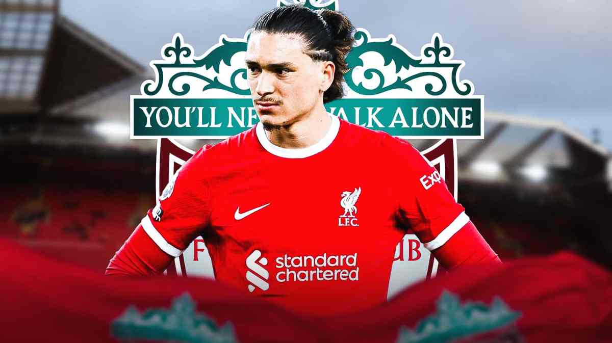 Darwin Nunez sad in front of the Liverpool logo