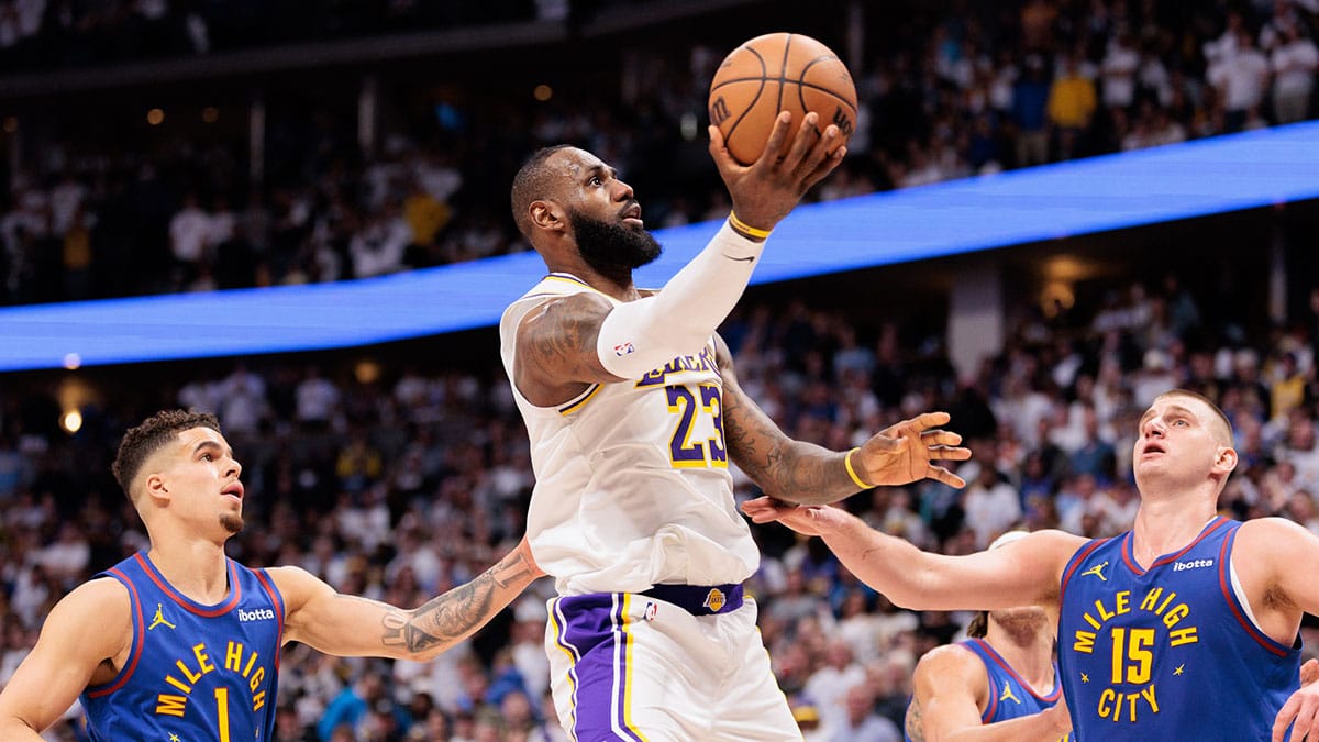 Apr 20, 2024; Denver, Colorado, USA; Los Angeles Lakers forward LeBron James (23) shoots the ball against Denver Nuggets center Nikola Jokic (15) during the fourth quarter in game one of the first round for the 2024 NBA playoffs at Ball Arena. Mandatory Credit: Andrew Wevers-USA TODAY Sports